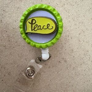 Green and purple Peace Badge Reel